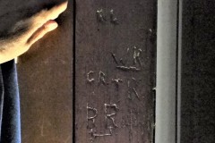 Initials on panelling by the door.